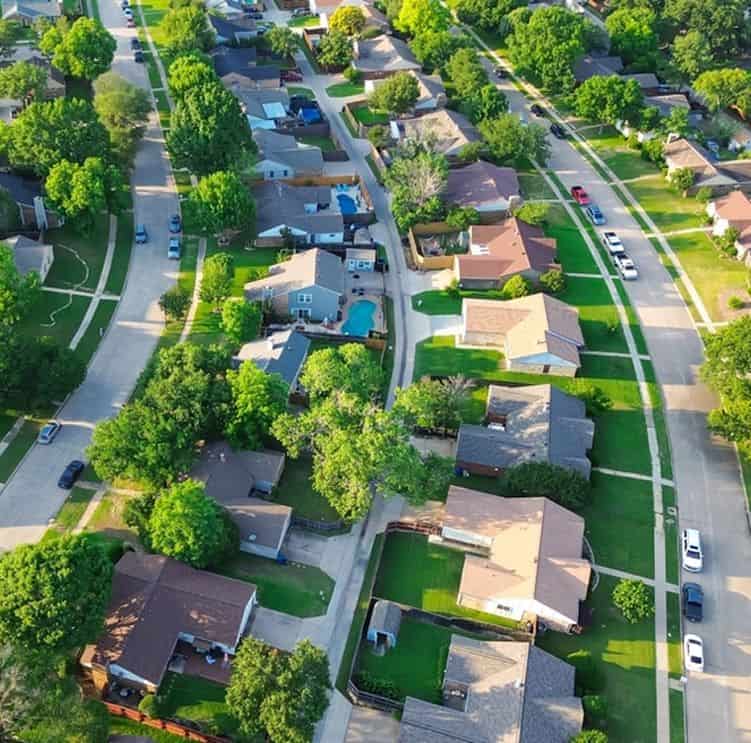Aerial view of houses and trees in Fika community in Elgin, TX.