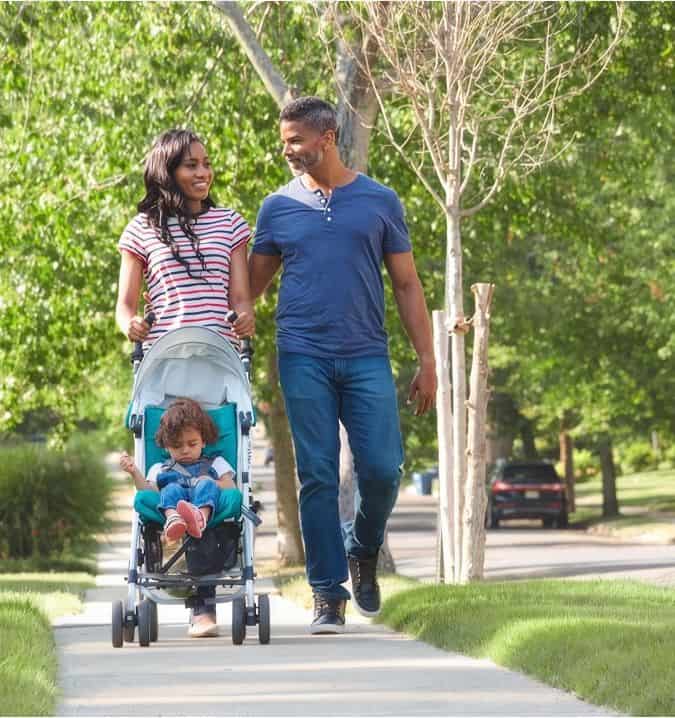 Family walking with stroller in Fika community in Elgin, TX.