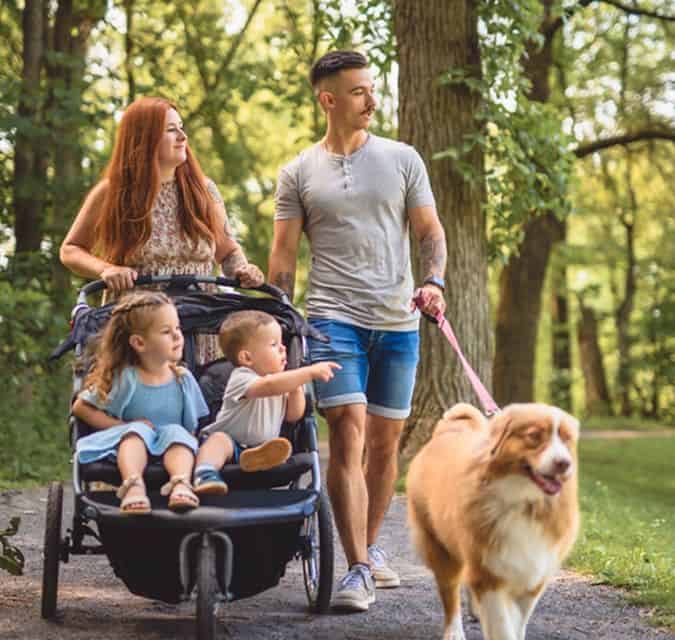 Family walking with dog in Fika community in Elgin, TX.
