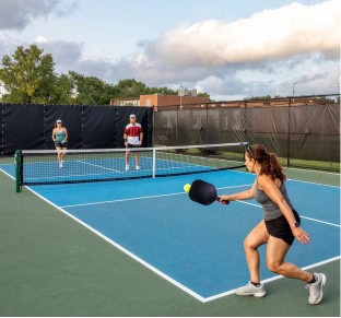 People playing tennis at Fika in Elgin, TX.