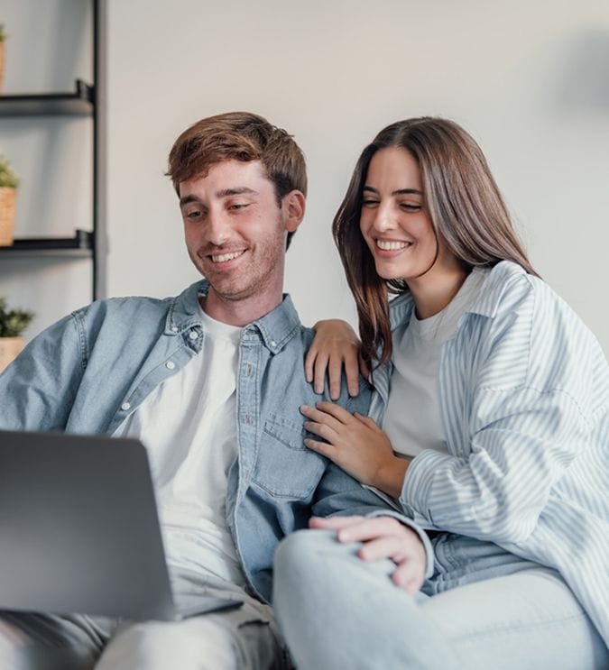 Young couple enjoying time together in a cozy indoor setting.