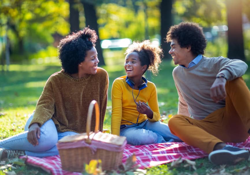 Family enjoying a picnic in a park at Fika in Elgin, TX.