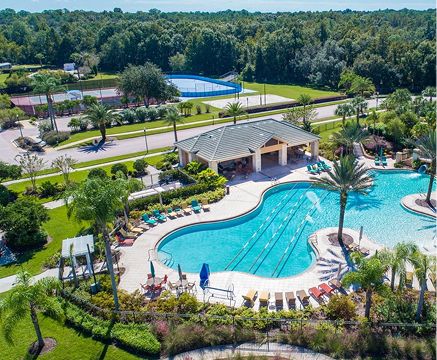 Community pool with lounge chairs and shaded pavilion in Fika in Elgin, TX.