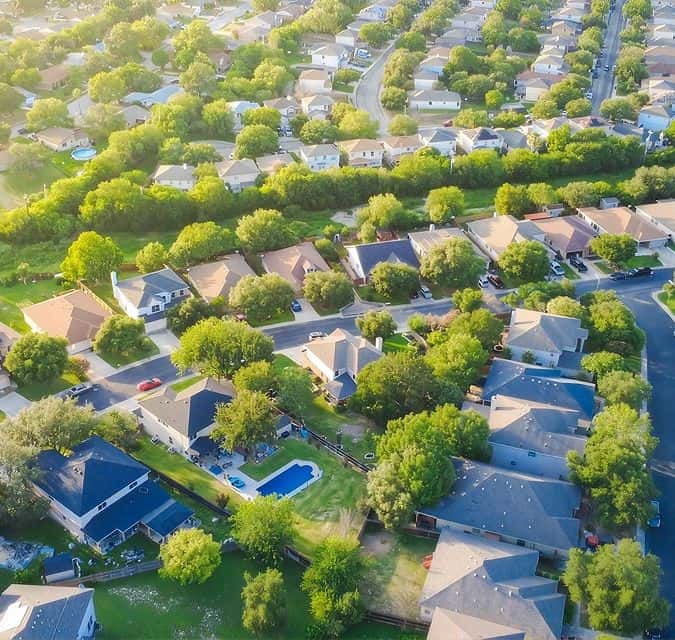 Aerial view of houses and trees in Fika community in Elgin, TX.