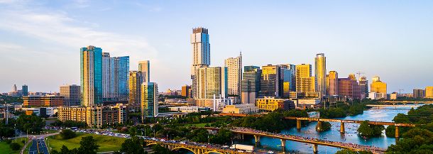 City skyline with tall buildings and river in Austin, Texas.