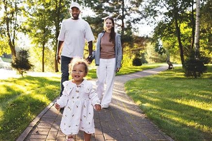 Family walking on a path in Fika community in Elgin, TX.