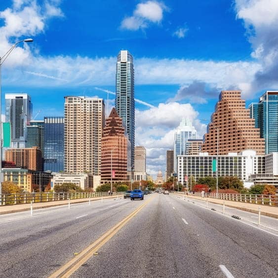 City skyline with tall buildings and blue sky in Austin, Texas.