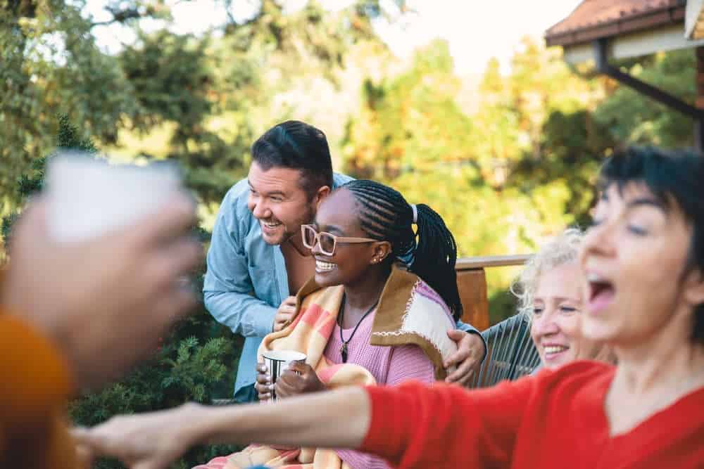 Group of people enjoying a social moment outdoors at Fika in Elgin, TX.